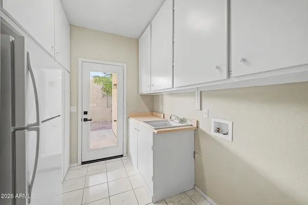 a kitchen with cabinets and a refrigerator