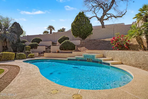 swimming pool view with a garden space
