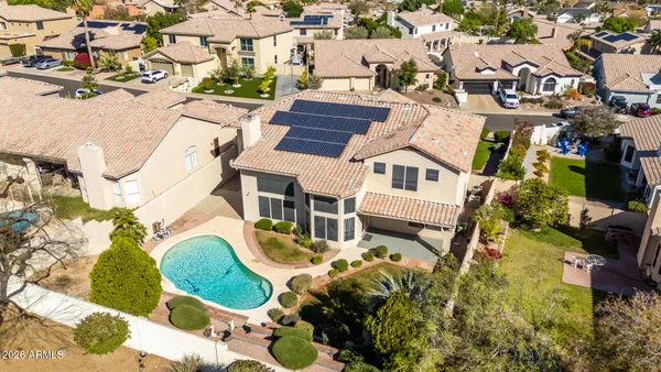 an aerial view of residential houses with outdoor space