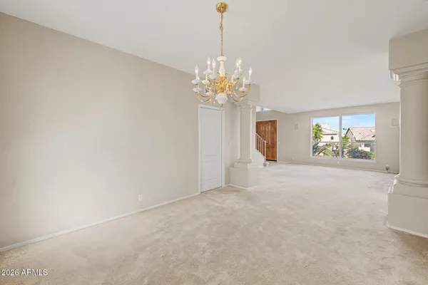 a view of a chandelier in big room and chandelier