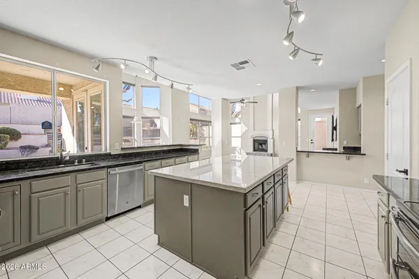 a kitchen with granite countertop a sink and cabinets