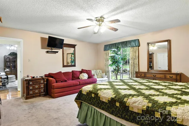 a bedroom with a bed couch and window