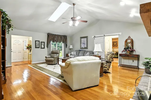 a living room with fireplace furniture and a chandelier