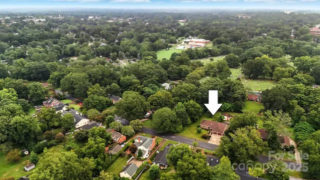 an aerial view of a house with yard porch and furniture