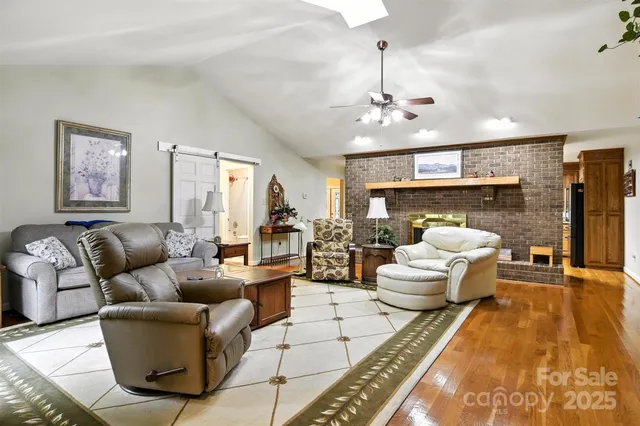 a living room with fireplace furniture and a chandelier
