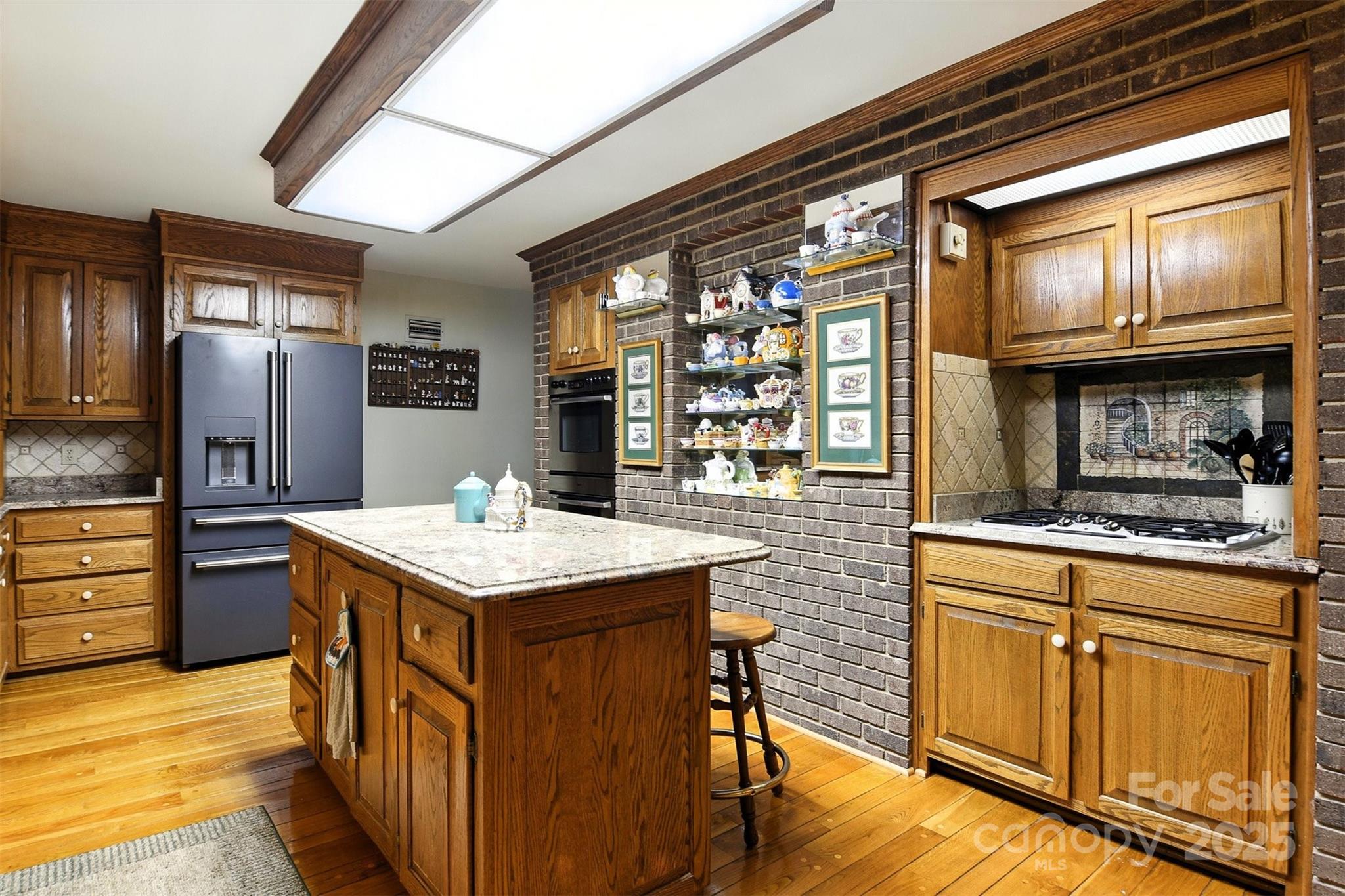 530 5th Street Northwest Hickory, NC 28601 - Photo 7 of 48 a kitchen with stainless steel appliances granite countertop a stove a refrigerator and a wooden cabinets