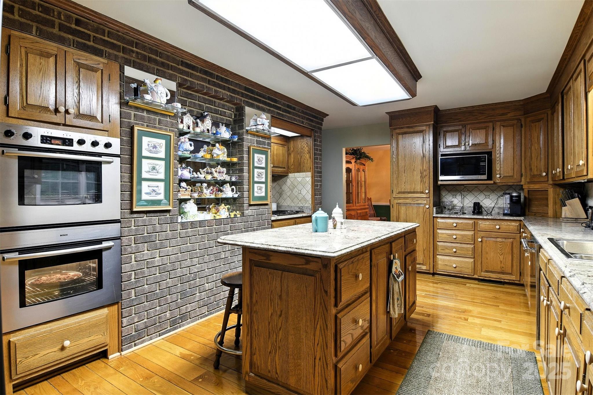 530 5th Street Northwest Hickory, NC 28601 - Photo 8 of 48 a kitchen with stainless steel appliances granite countertop a stove a sink and a microwave