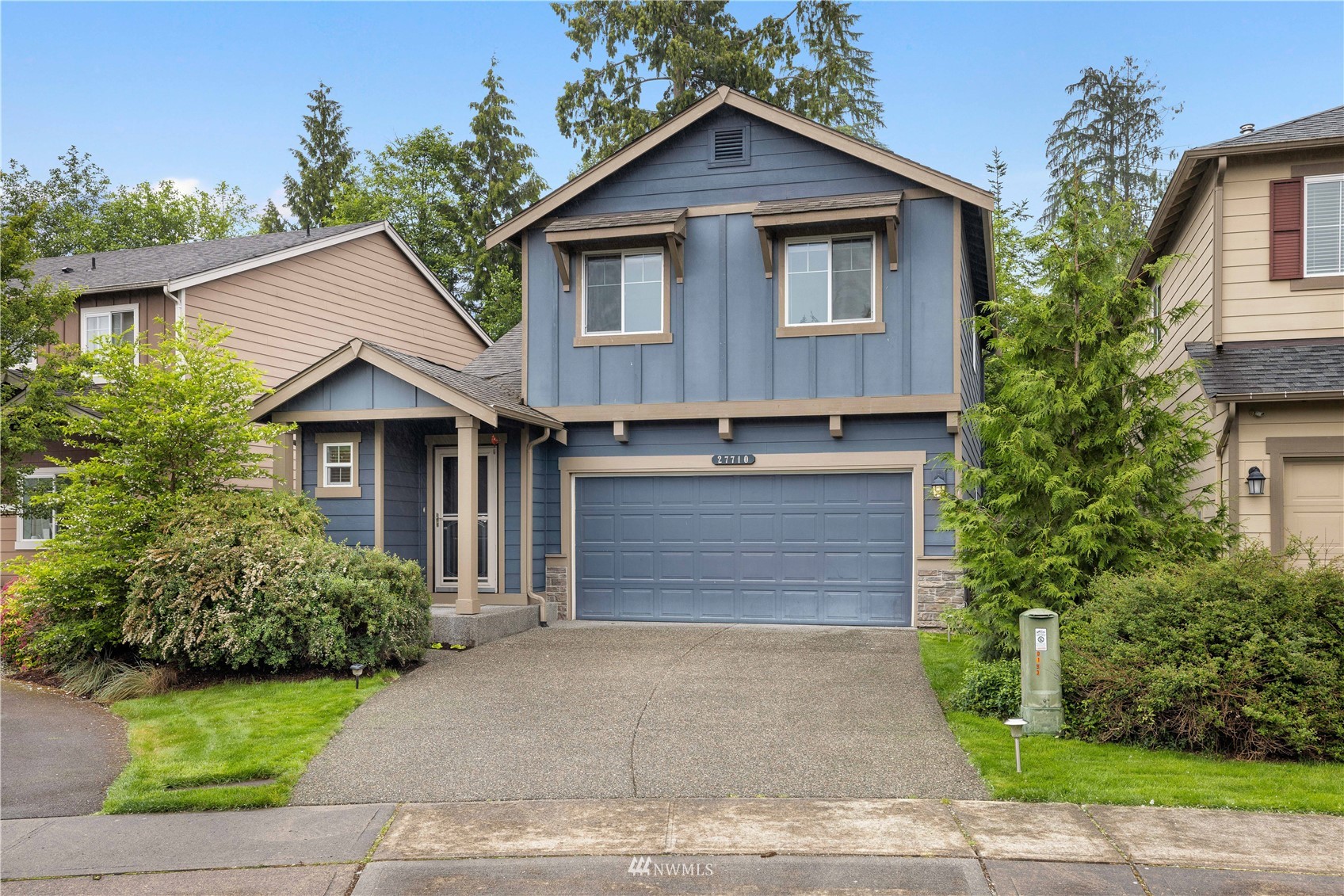 27710 Northeast 146th Way Duvall, WA 98019 - Photo 1 of 28 a front view of a house with a yard and garage