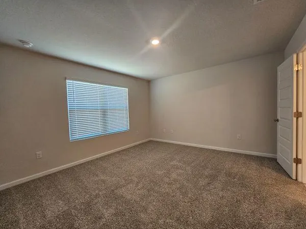 a view of an empty room and closet area
