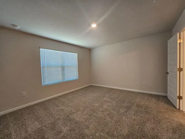 a view of an empty room and closet area