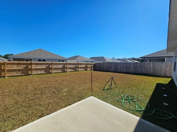 a view of a backyard of the house