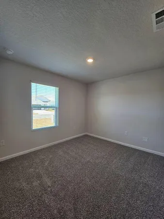 an empty room with a empty space and windows