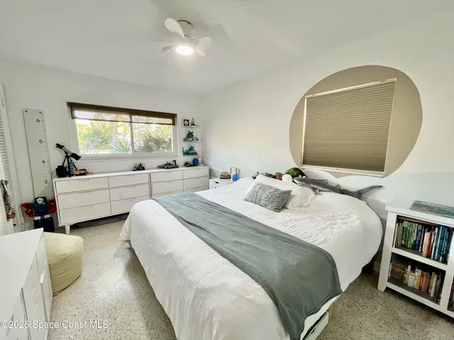 a bedroom with bed and a window