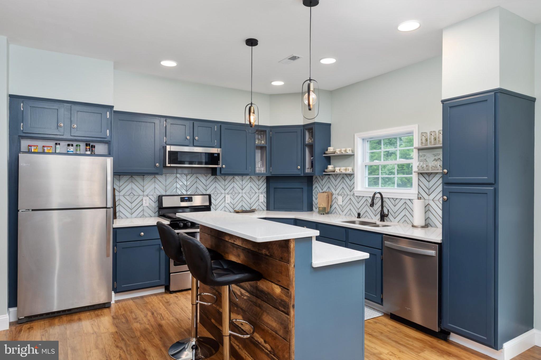1195 Mountain View Drive Rileyville, VA 22650 - Photo 8 of 35 a kitchen with stainless steel appliances granite countertop a refrigerator a sink a stove a microwave and a refrigerator