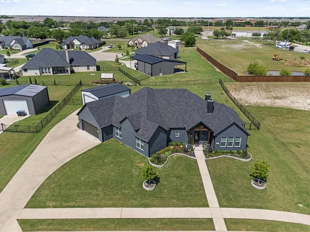 an aerial view of residential houses with outdoor space
