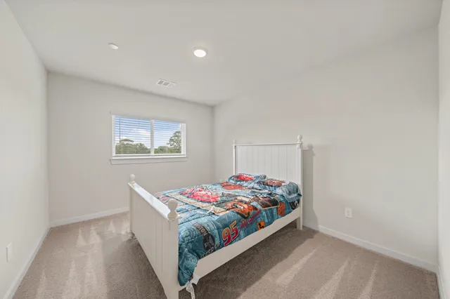 a bedroom with a bed and a wall painting