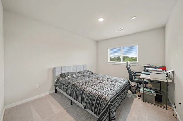 a bedroom with a bed and a desk