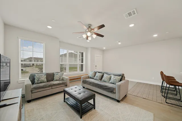 a living room with furniture and a large window