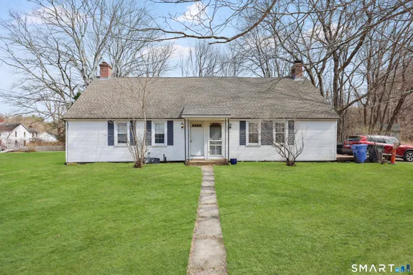 a front view of a house with a garden and porch