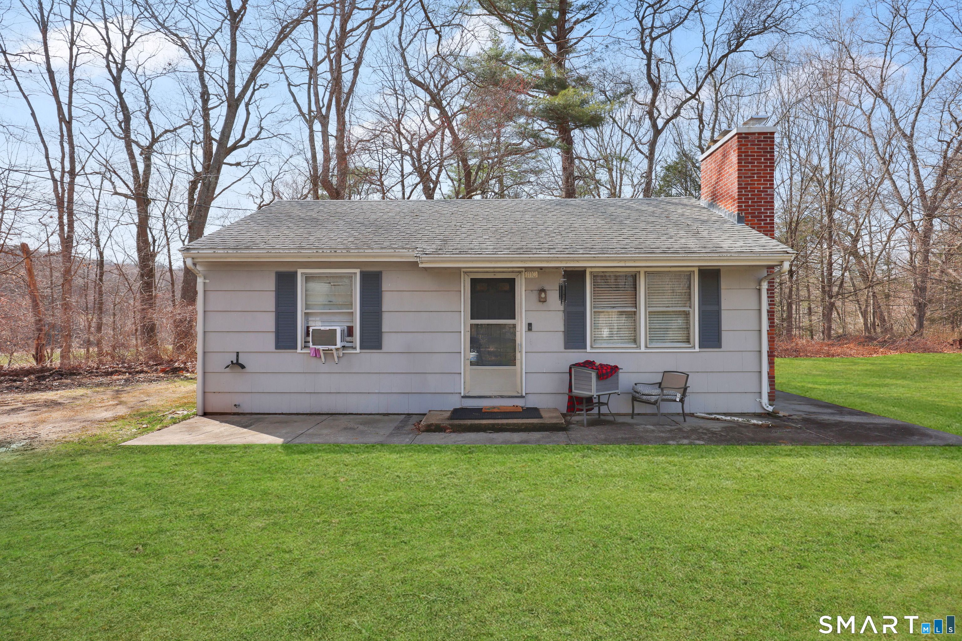 111 Depot Road Mansfield, CT 06268 - Photo 5 of 7 a front view of a house with a garden and trees