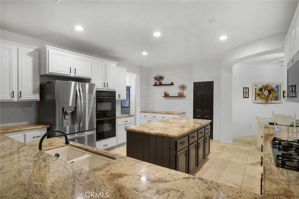 18604 Sunset Knoll Drive Riverside, CA 92504 - Photo 11 of 66 a large kitchen with kitchen island a sink stove and refrigerator