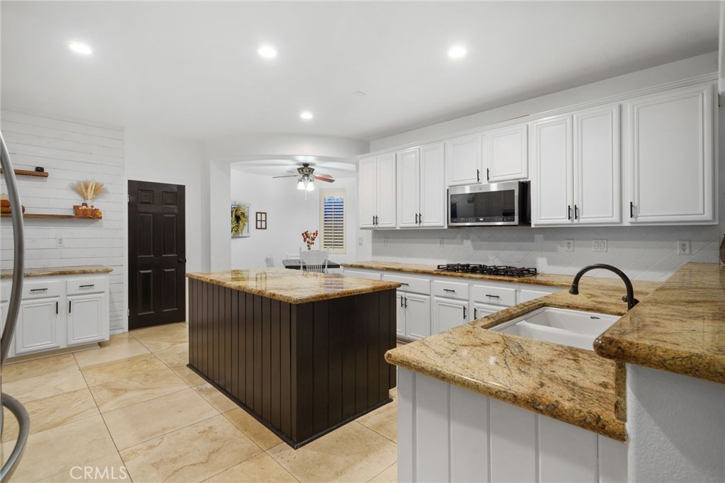 18604 Sunset Knoll Drive Riverside, CA 92504 - Photo 12 of 66 a kitchen with a sink stove and cabinets