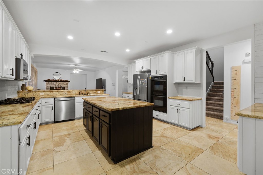 18604 Sunset Knoll Drive Riverside, CA 92504 - Photo 14 of 66 a kitchen with stainless steel appliances granite countertop a stove oven and a refrigerator