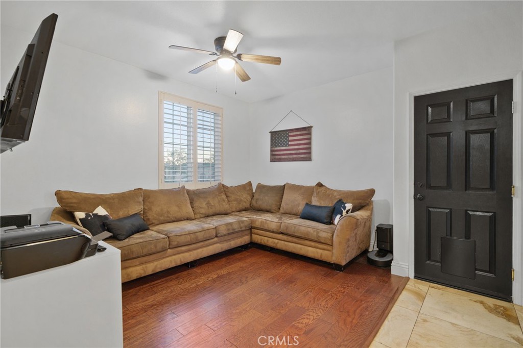 18604 Sunset Knoll Drive Riverside, CA 92504 - Photo 19 of 66 a living room with furniture a ceiling fan and a window