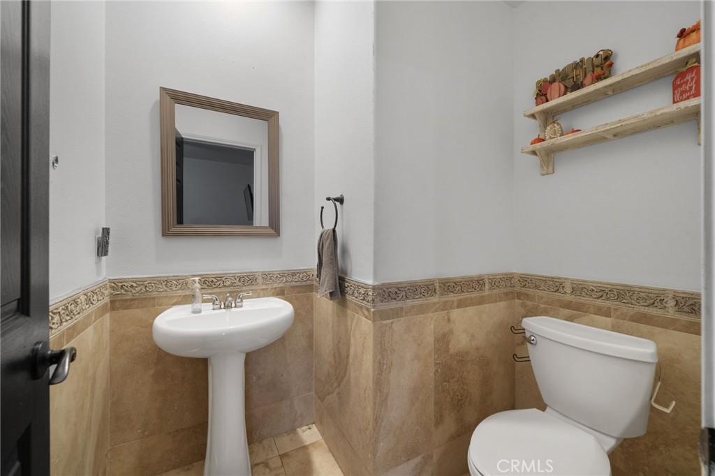 18604 Sunset Knoll Drive Riverside, CA 92504 - Photo 24 of 66 a bathroom with a toilet sink and mirror