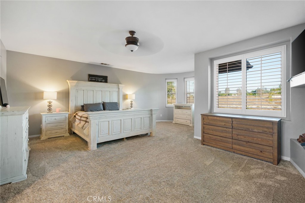 18604 Sunset Knoll Drive Riverside, CA 92504 - Photo 26 of 66 a bedroom with a white bed and dresser