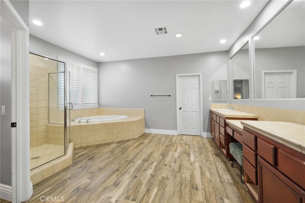 18604 Sunset Knoll Drive Riverside, CA 92504 - Photo 29 of 66 a spacious bathroom with a tub double vanity sink and a mirror
