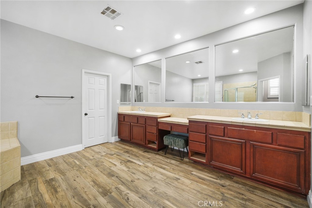 18604 Sunset Knoll Drive Riverside, CA 92504 - Photo 30 of 66 a spacious bathroom with a tub sink and mirror