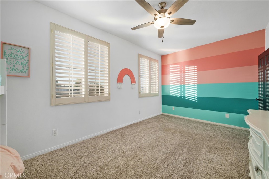 18604 Sunset Knoll Drive Riverside, CA 92504 - Photo 35 of 66 a view of a livingroom with a ceiling fan and window