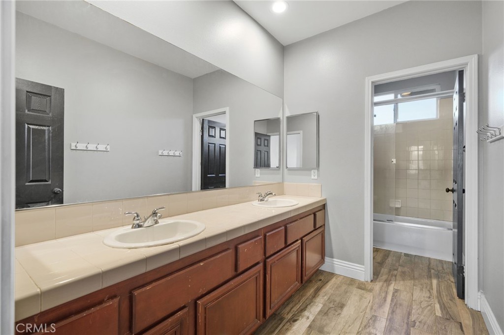 18604 Sunset Knoll Drive Riverside, CA 92504 - Photo 37 of 66 a bathroom with a sink double vanity granite tub and shower