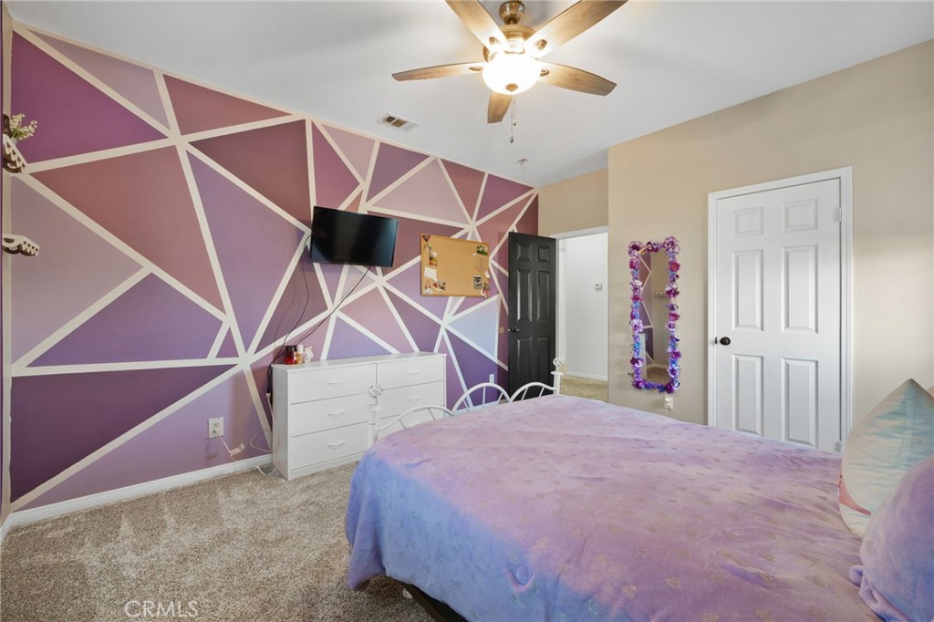 18604 Sunset Knoll Drive Riverside, CA 92504 - Photo 41 of 66 a bed room with a bed and a ceiling fan