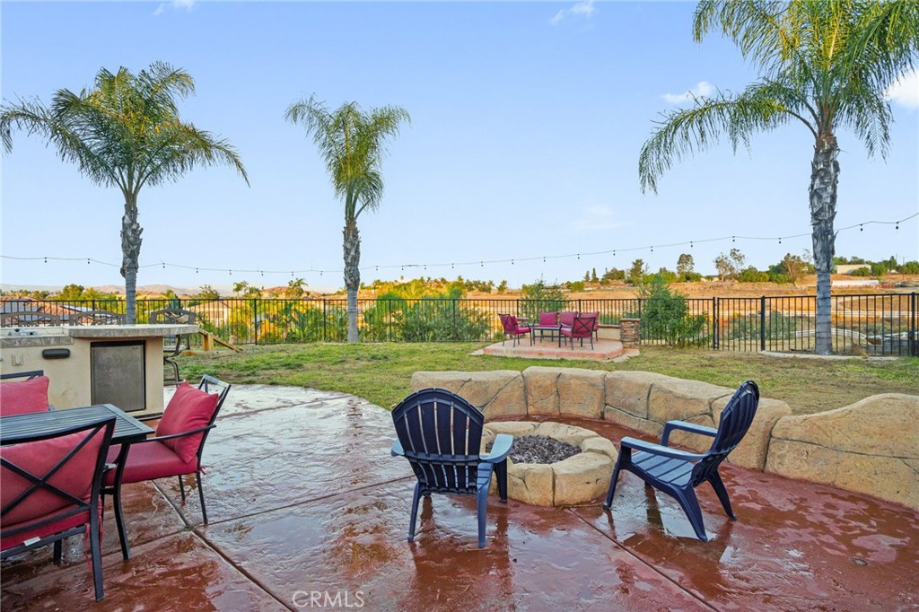 18604 Sunset Knoll Drive Riverside, CA 92504 - Photo 58 of 66 a view of a chairs and table in patio with a lake view