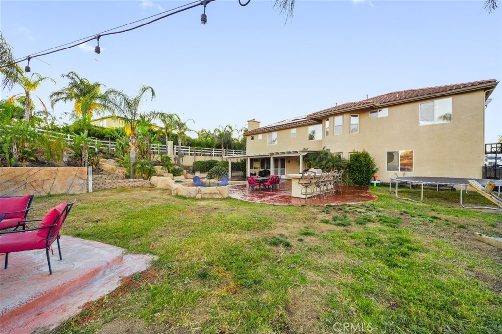 18604 Sunset Knoll Drive Riverside, CA 92504 - Photo 59 of 66 a view of a patio with table and chairs potted plants and large tree