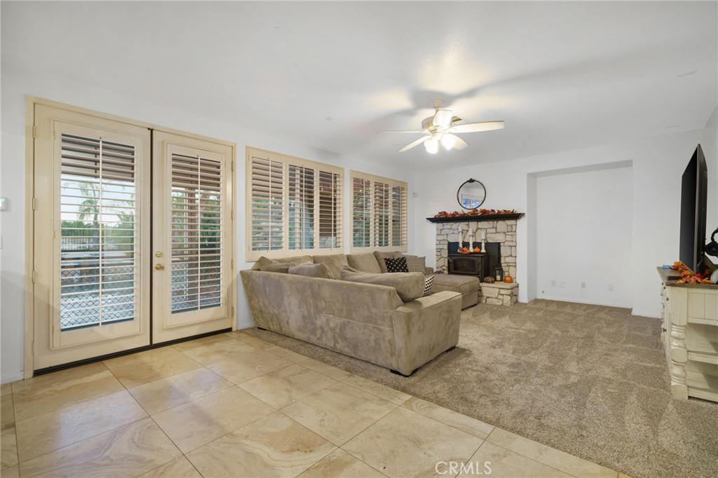 18604 Sunset Knoll Drive Riverside, CA 92504 - Photo 8 of 66 a living room with furniture a fireplace and a flat screen tv