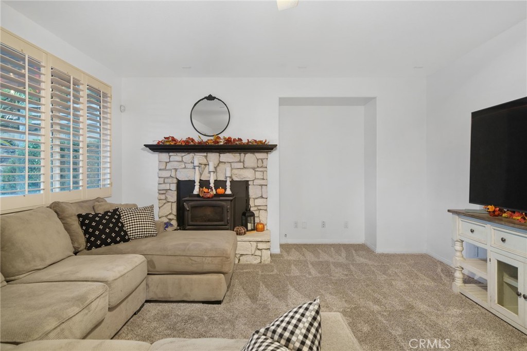 18604 Sunset Knoll Drive Riverside, CA 92504 - Photo 9 of 66 a living room with furniture a flat screen tv and a fireplace
