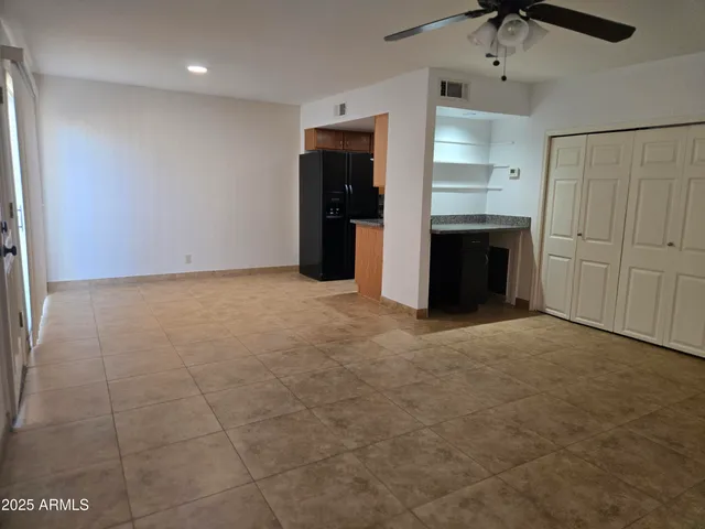 a view of a kitchen with a sink and a refrigerator