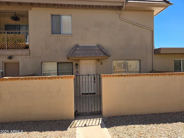 a wooden bench sitting in front of a building