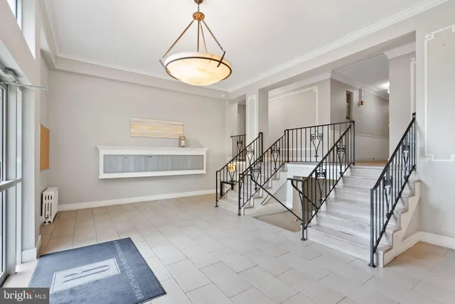 a view of entryway and hall with a chandelier