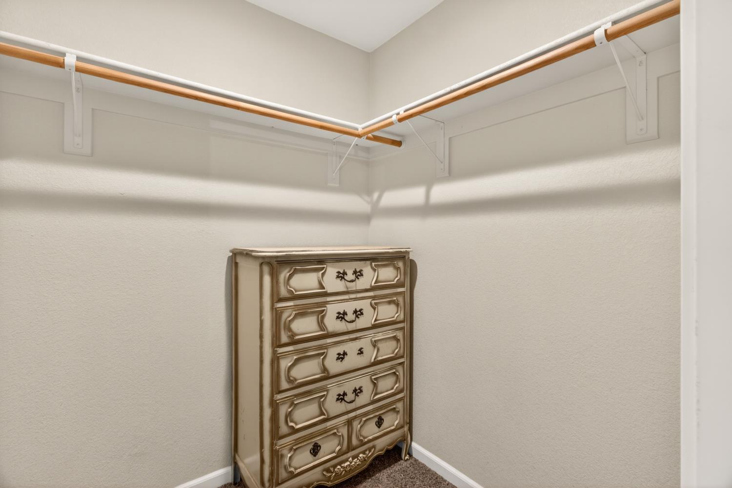 6332 Horseshoe Bar Road Loomis, CA 95650 - Photo 29 of 85 Corner closet featuring double hanging rods and wall-mounted shelving