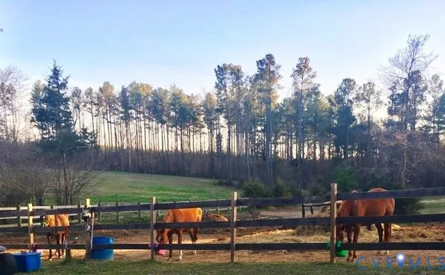 a view of a table and chairs in patio with wooden fence