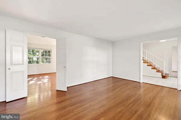 a view of wooden floor and windows in a room
