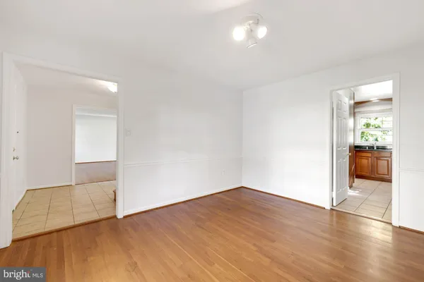 a large kitchen with stainless steel appliances granite countertop a refrigerator and a stove