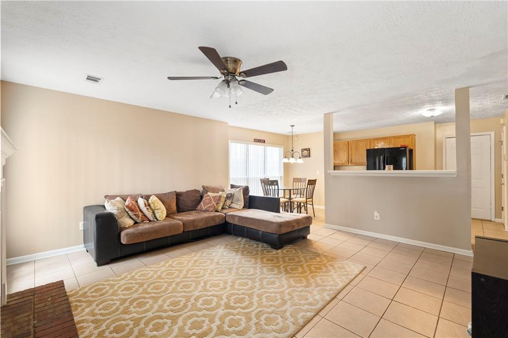 905 Ahearn Court Suwanee, GA 30024 - Photo 11 of 26 a living room with furniture and a wooden floor