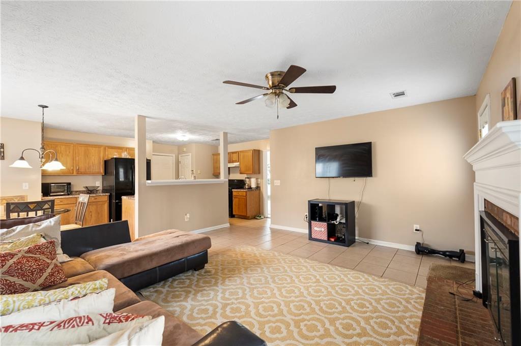 905 Ahearn Court Suwanee, GA 30024 - Photo 12 of 26 a living room with furniture and a flat screen tv