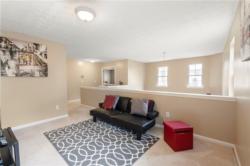 905 Ahearn Court Suwanee, GA 30024 - Photo 15 of 26 a living room with furniture and a rug
