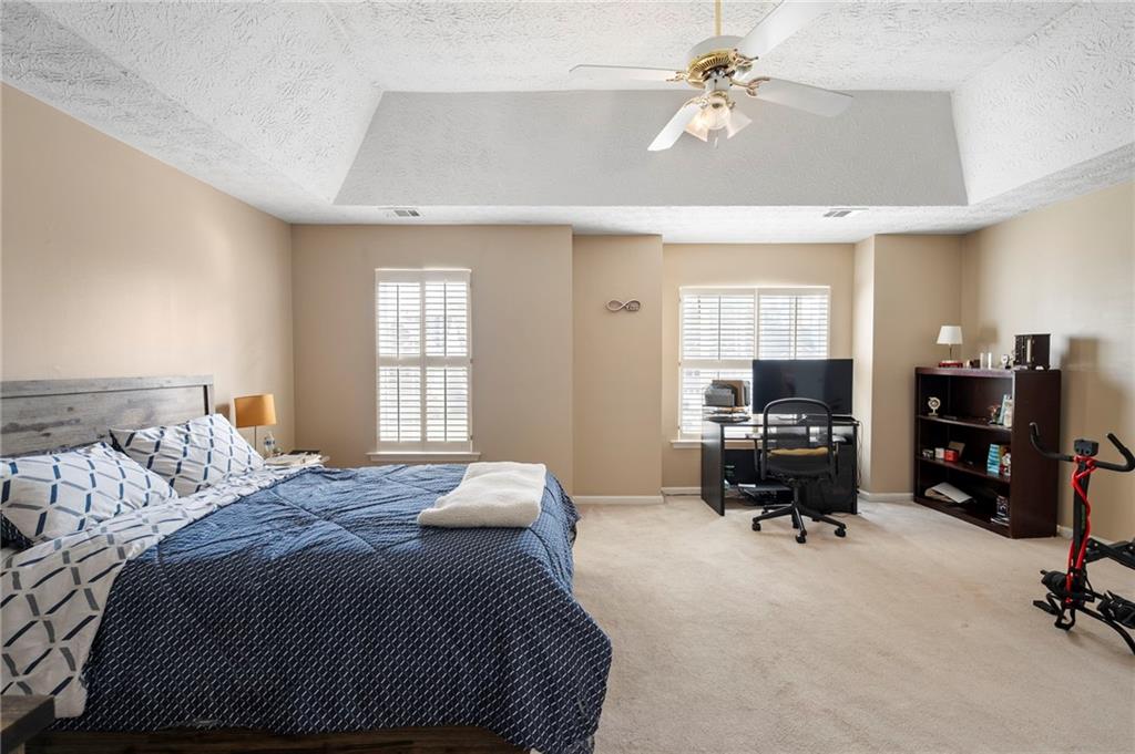 905 Ahearn Court Suwanee, GA 30024 - Photo 18 of 26 a bed room with a bed furniture and a computer
